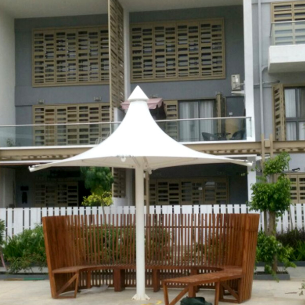 Fixed tensile umbrella structure with central column over poolside seating