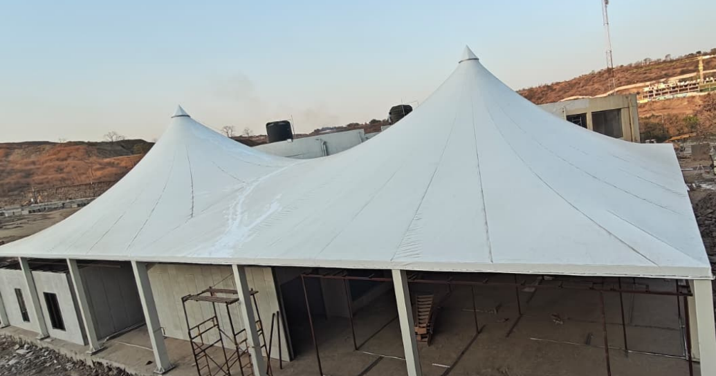Single-cone tensile structure over a garden seating area in Pune