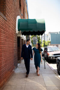 Couple walking under a drop arm awning